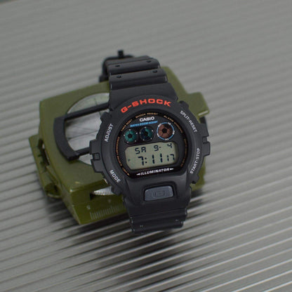 Black Casio G-Shock digital watch on a gray surface